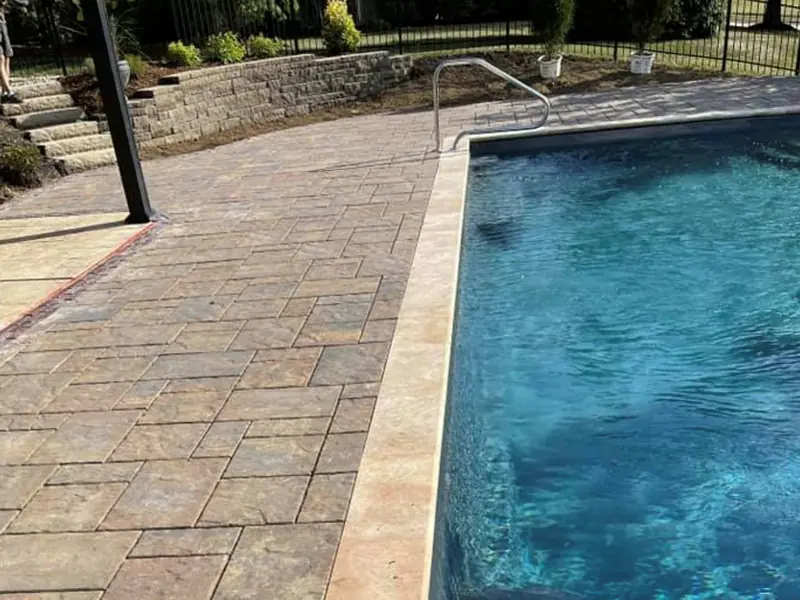 Paver pool deck with a bullnose coping edge along the pool
