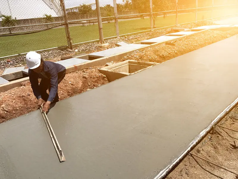 Finisher screeding a long formed walkway slab